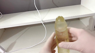 I give a handjob to the dildo with oily hands in medical white gloves