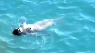Beach Voyeur. Hot babe with big natural tits gives head on