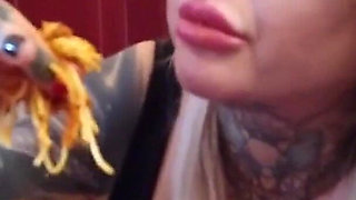 Blonde tattooed milf eats spaghetti on the toilet