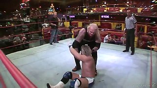 blonde babe fights a guy in a wrestling match