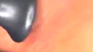 Ebony Girl Gives Her Feet a Massage with a Massage Gun