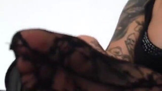 Tattooed blonde lady shows her feet