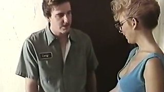 Retro blonde flashes her tits and rubs a guy's dick in an office