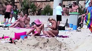 Voyeur films two hot babes rubbing sunscreen on each other