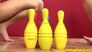 Pissing babes stuffing bowling pins in vag