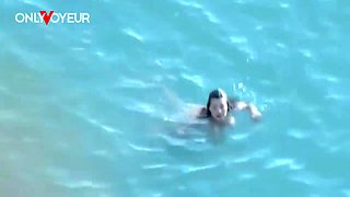 Beach Voyeur. Hot girl with big natural tits gives head on a public beach