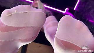 Under the Feet of the Mistress in White Pantyhose on the Bar Counter