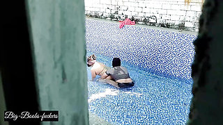 A neighboring couple was seen secretly having sex in the swimming pool.
