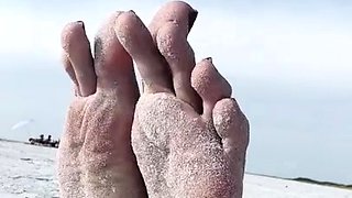 Milf seductress showing off her fabulous feet outdoors