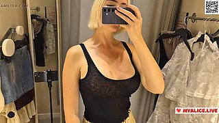 Trying on transparent clothes in the fitting room. Naked blonde flashed her boobs in a public place