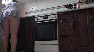 A milf cleans the kitchen without panties.