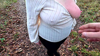 Squeezing her hard naked nipples outdoors