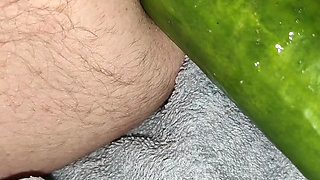 My wife is fucking my ass with a huge cucumber.