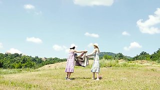 Eve Black and Amanda Clarke are 69ing in a field