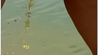 Watch Her Strip Down And Get Naked At This Beach Where She Takes A Piss And Gets Pissed On