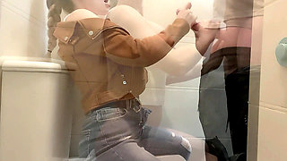 Busty Blonde Sucks Cock in the School Bathroom