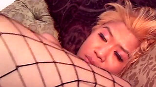 Sexy Asian babe in fishnets slides on a thick dong with her ass and pussy