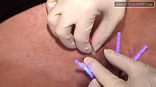 MILF lies on the bed as pussy gets injected wit syringes