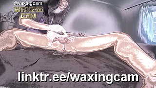 A Nurse in White Gloves Waxes a Guy