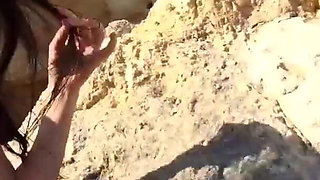 Alone lush Russian babe toys her cunt on the rock on the sea shore