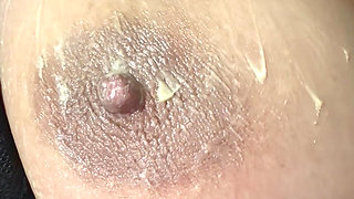 Hot sexy blonde fills her huge nipple with cream