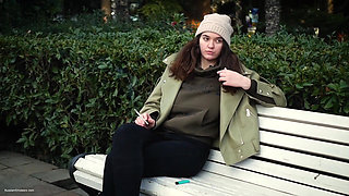 Young Brunette Is Taking an Unhurried Stroll with Allwhite 120mm Cigarette