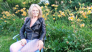 A Mature Woman Is Wearing Sheer Tights Outside.