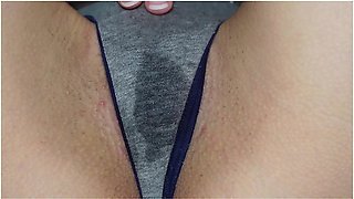 Wet panties betray her arousal as she touches herself