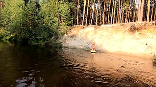 Tattooed Babe Strips and Swims on a SUP Board in the Forest