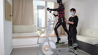 Mz27 - a Girl Bound in Latex Walks on a Treadmill